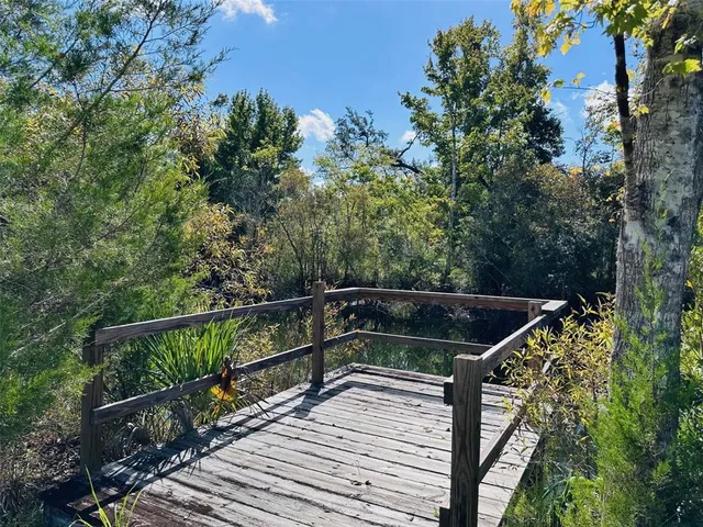 a view of balcony with wooden floor and fence
