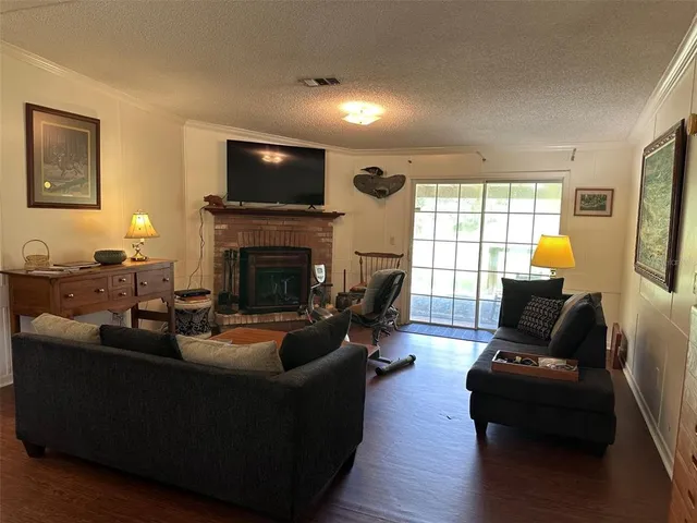a living room with fireplace furniture and a flat screen tv