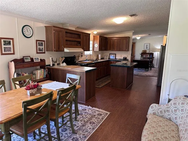 a kitchen with a refrigerator and a dining table