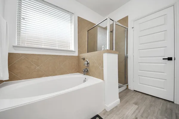 a bathroom with a bathtub and a window