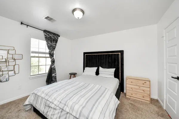 a bedroom with a bed and a window
