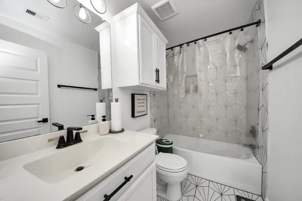 a bathroom with a sink a toilet and a bathtub
