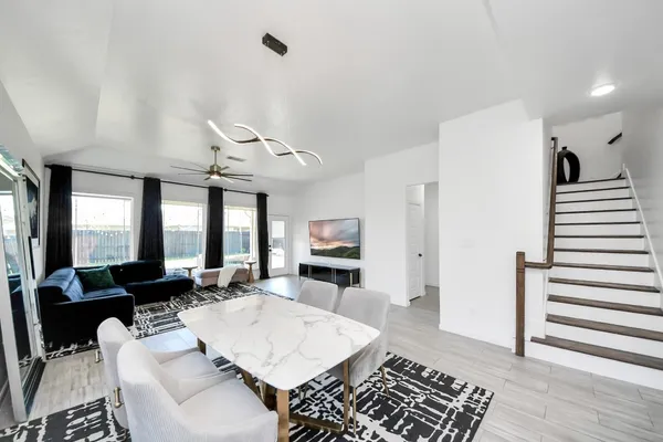 a living room with furniture and wooden floor