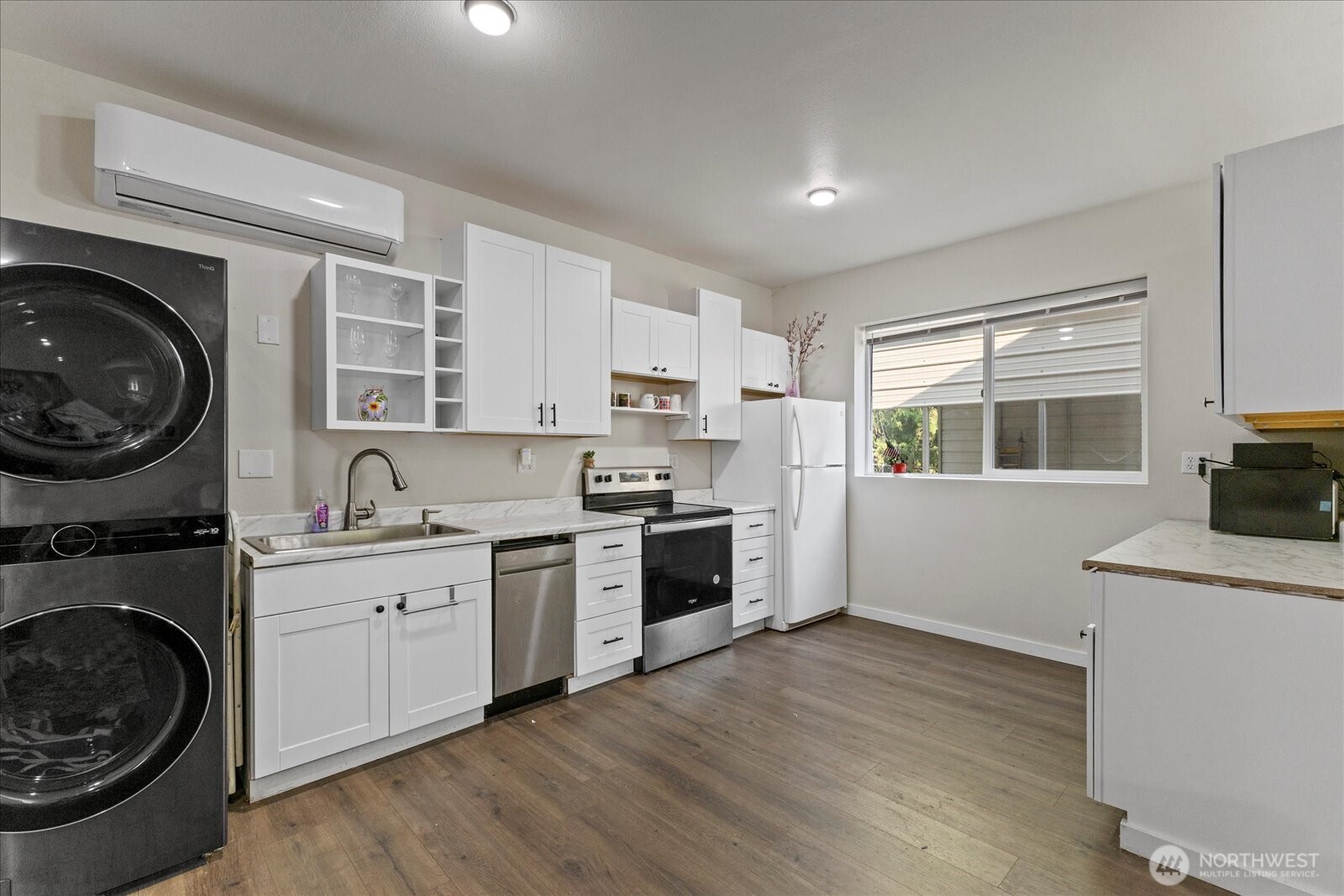 22005 260th Avenue Southeast Maple Valley, WA 98038 - Photo 28 of 39 a kitchen with a stove top oven sink and cabinets