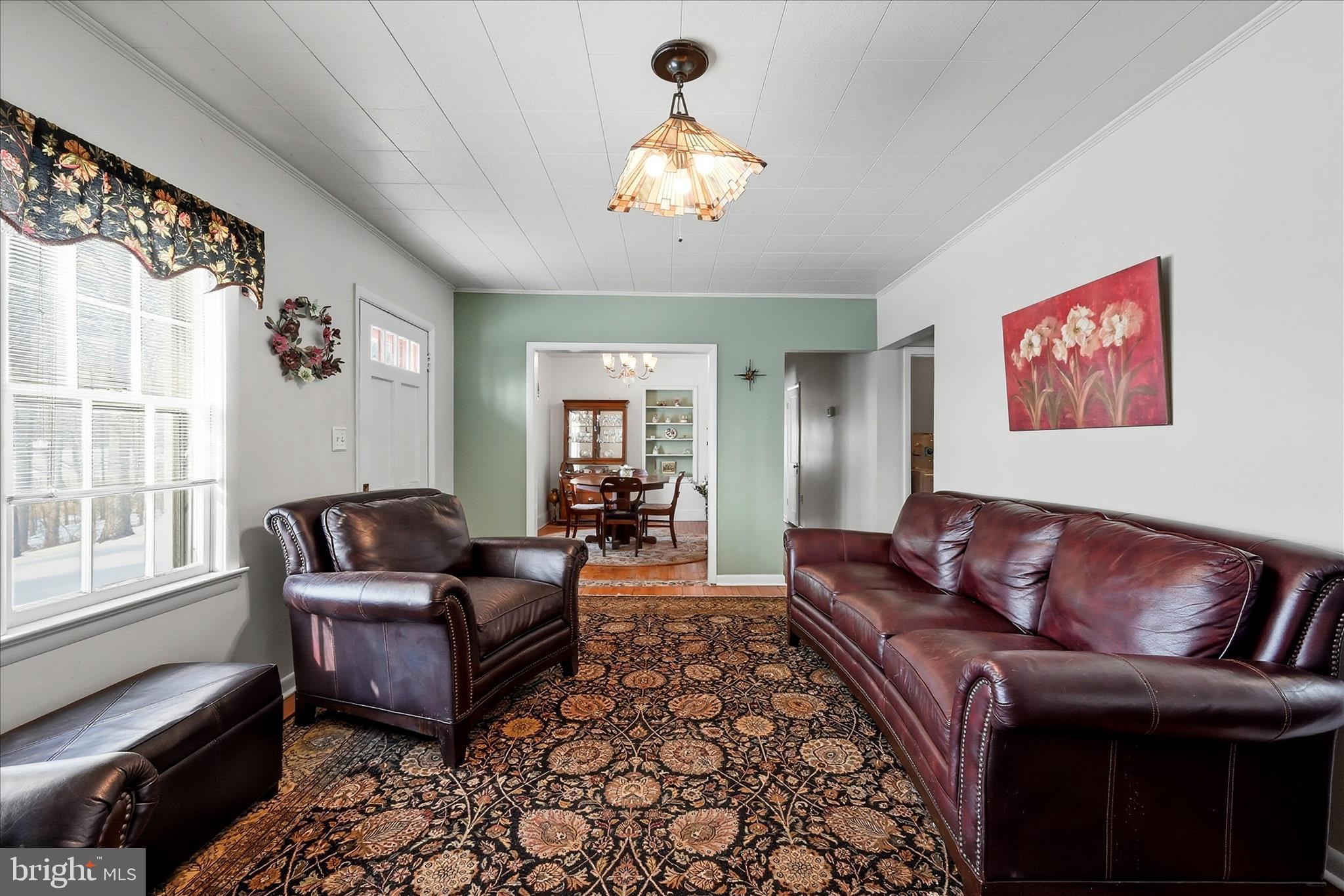 18758 Telegraph Springs Road Purcellville, VA 20132 - Photo 7 of 59 a living room with furniture a chandelier and a window