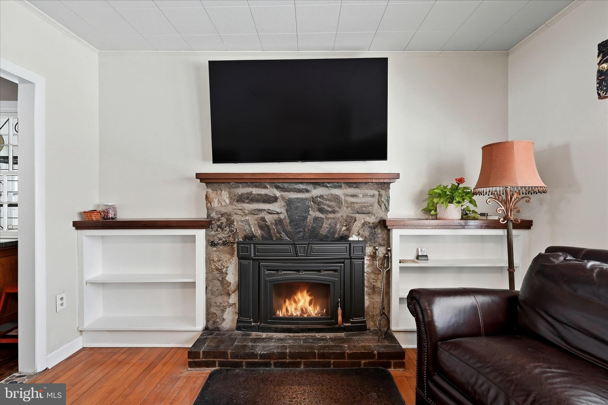 18758 Telegraph Springs Road Purcellville, VA 20132 - Photo 8 of 59 a living room with a fireplace furniture and a flat screen tv