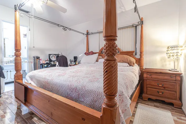 a bed sitting in a bedroom next to a window