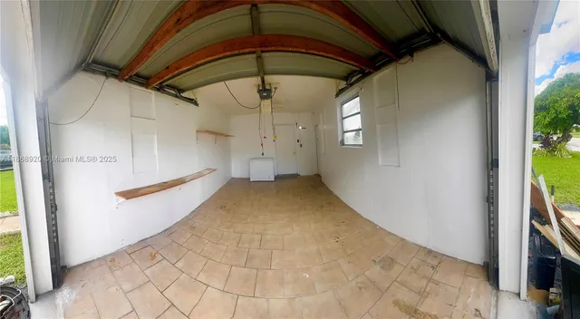 a view of a hallway with wooden walls and entryway