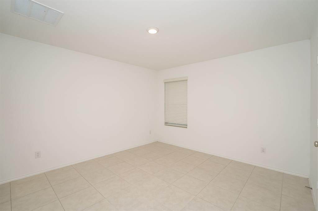 14841 Firerock Road Haslet, TX 76052 - Photo 12 of 18 an empty room with a empty space and window