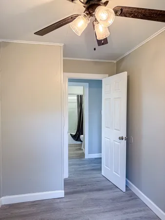 a view of a hallway with wooden floor and staircase