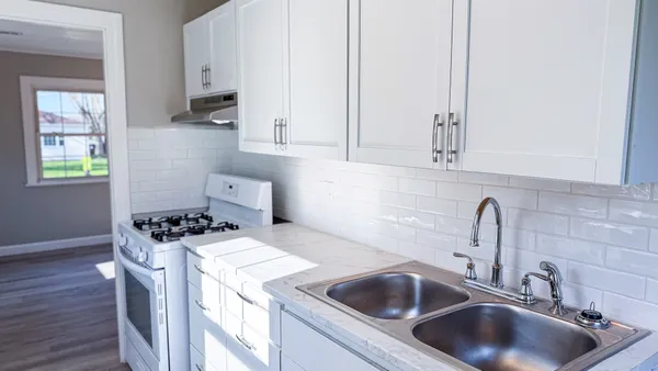 a kitchen with a sink stove and cabinets