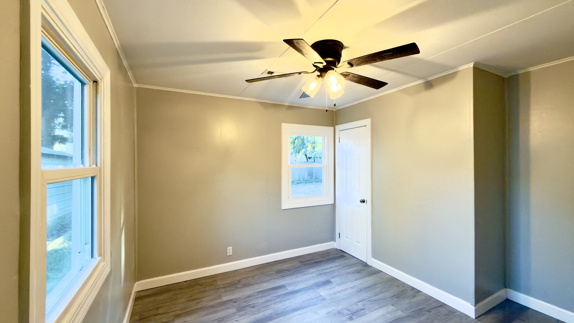 1024 Eastview Drive Rantoul, IL 61866 - Photo 8 of 12 a view of an empty room with wooden floor and a window