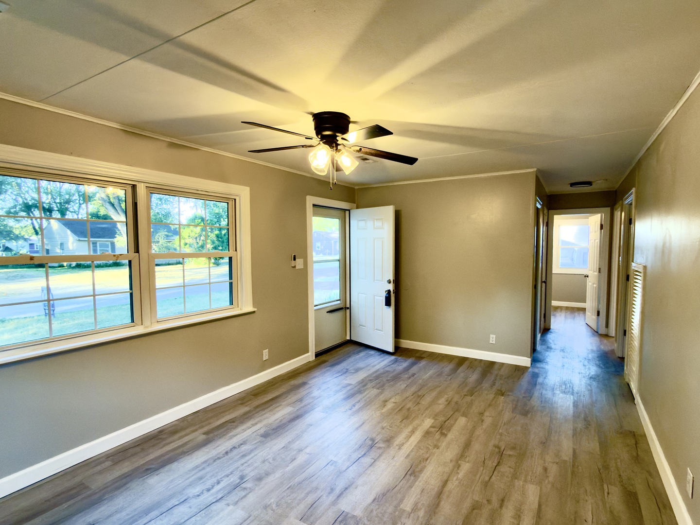 1024 Eastview Drive Rantoul, IL 61866 - Photo 9 of 12 a view of an empty room with wooden floor and a window
