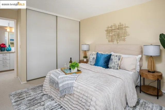 a bedroom with a bed and a lamp