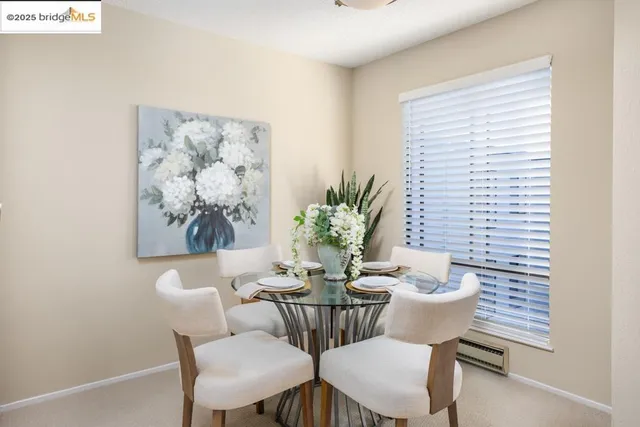 a dining room with furniture and window