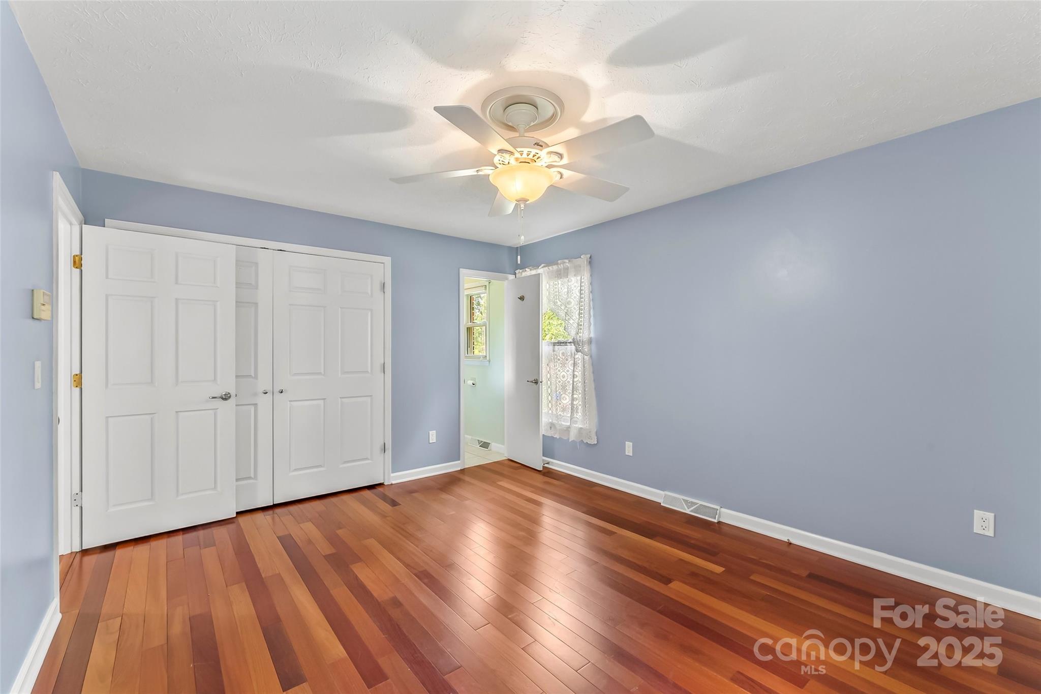 2423 Warrior Fork Trail Morganton, NC 28655 - Photo 17 of 42 wooden floor in an empty room with a window
