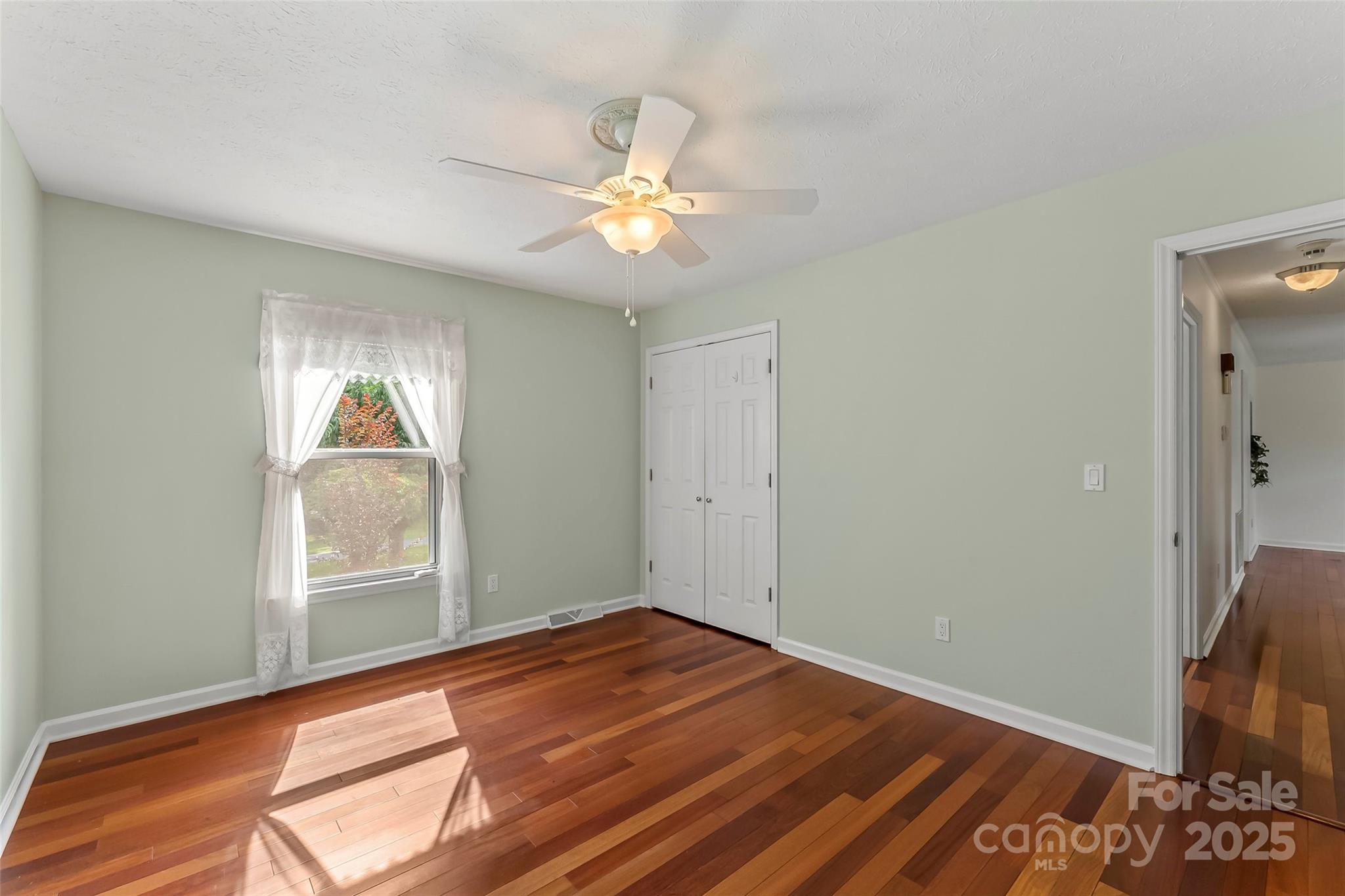 2423 Warrior Fork Trail Morganton, NC 28655 - Photo 21 of 42 a view of empty room with wooden floor and fan