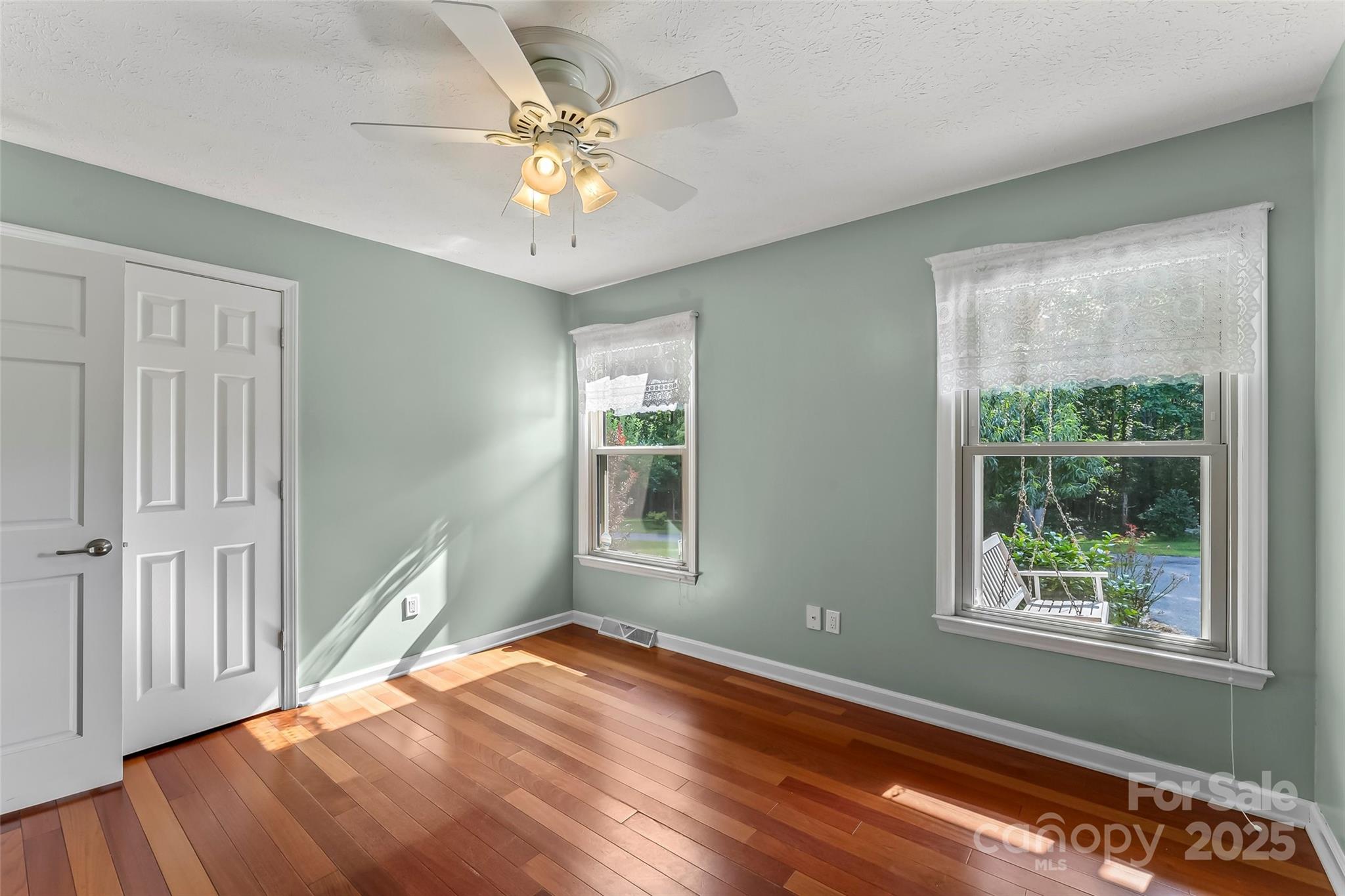 2423 Warrior Fork Trail Morganton, NC 28655 - Photo 22 of 42 a view of an empty room with wooden floor and a window