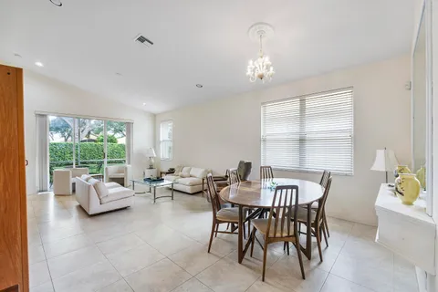 a view of a dining room with furniture a rug and wooden floor