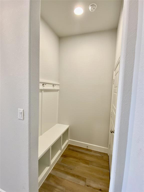 1937 Halkin Road Celina, TX 75009 - Photo 18 of 20 Entryway with built-in storage bench featuring cubbies, coat hooks, wood-finish flooring, and recessed lighting
