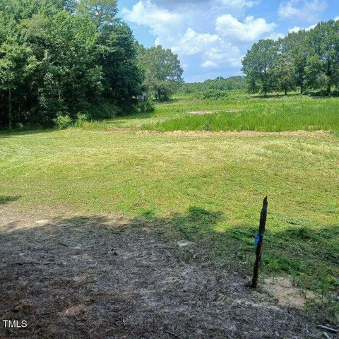 a view of a field with an ocean
