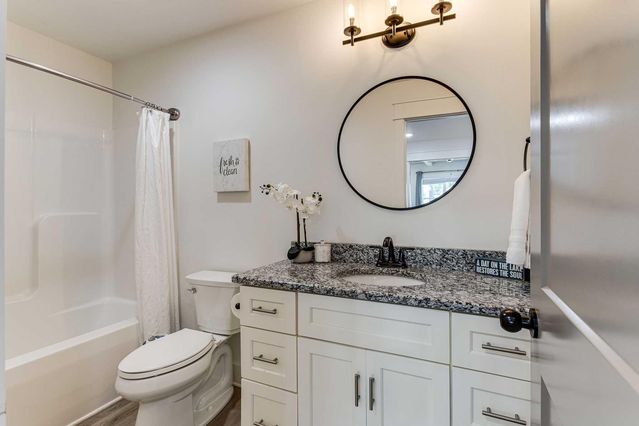 111 Barefoot Way Winchester, TN 37398 - Photo 16 of 33 a bathroom with a granite countertop toilet sink and mirror