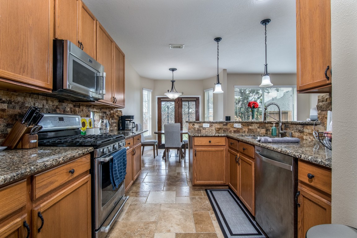 20011 Castlegreen Drive Spring, TX 77388 - Photo 10 of 32 Kitchen with granite counters and stainless appliances.
