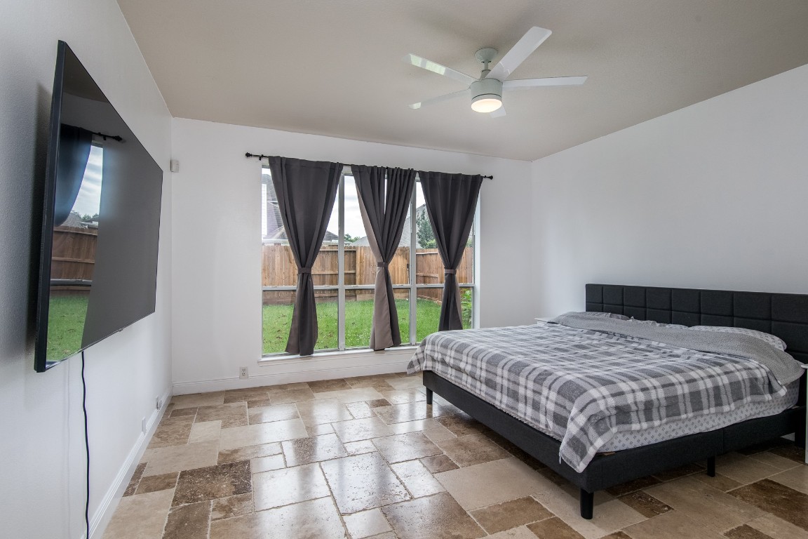 20011 Castlegreen Drive Spring, TX 77388 - Photo 17 of 32 Primary bedroom down also has travertine flooring.