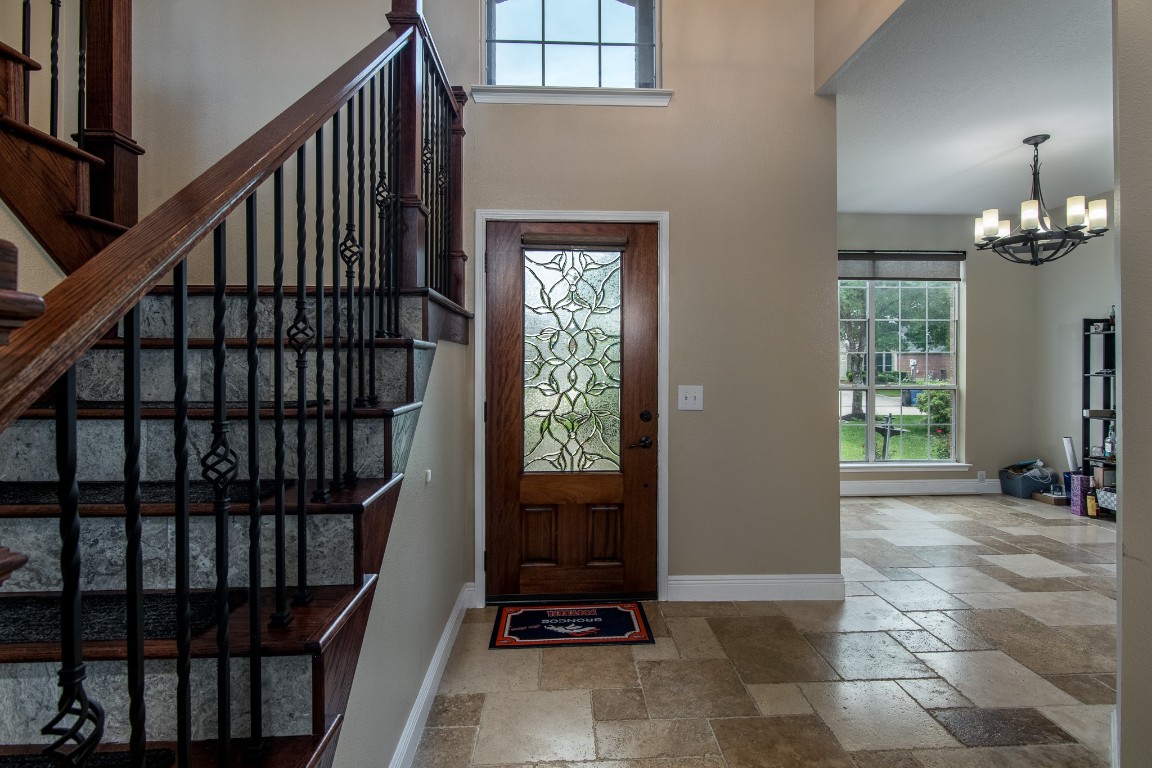 20011 Castlegreen Drive Spring, TX 77388 - Photo 4 of 32 Entry is accented by an upgraded staircase with wrought iron balusters and red oak railing.