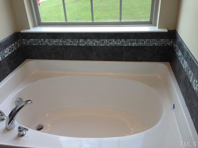 2728 Shepherd Valley Street Raleigh, NC 27610 - Photo 13 of 15 a close view of a bathtub in a bathroom