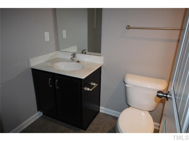2728 Shepherd Valley Street Raleigh, NC 27610 - Photo 14 of 15 a bathroom with a toilet sink and mirror