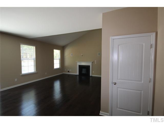 2728 Shepherd Valley Street Raleigh, NC 27610 - Photo 7 of 15 a view of an empty room with wooden floor and a window