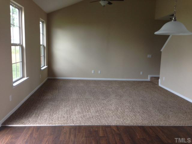 2728 Shepherd Valley Street Raleigh, NC 27610 - Photo 9 of 15 an empty room with wooden floor and windows