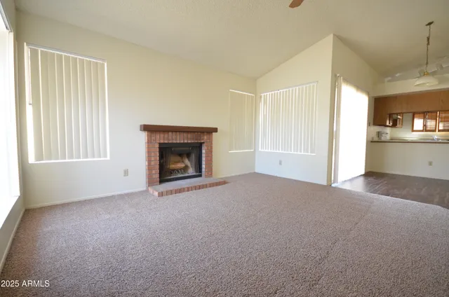 a view of empty room with window and fireplace