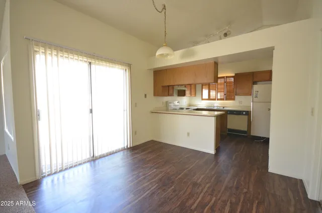 a view of kitchen with granite countertop cabinets and wooden floor