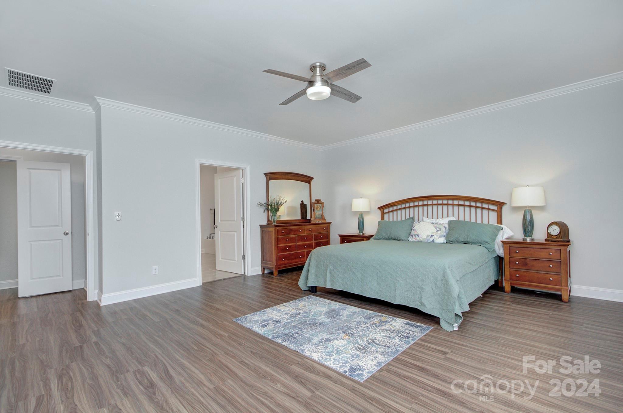 7047 Messina Road Fort Mill, SC 29707 - Photo 23 of 32 a bedroom with a bed and wooden floor