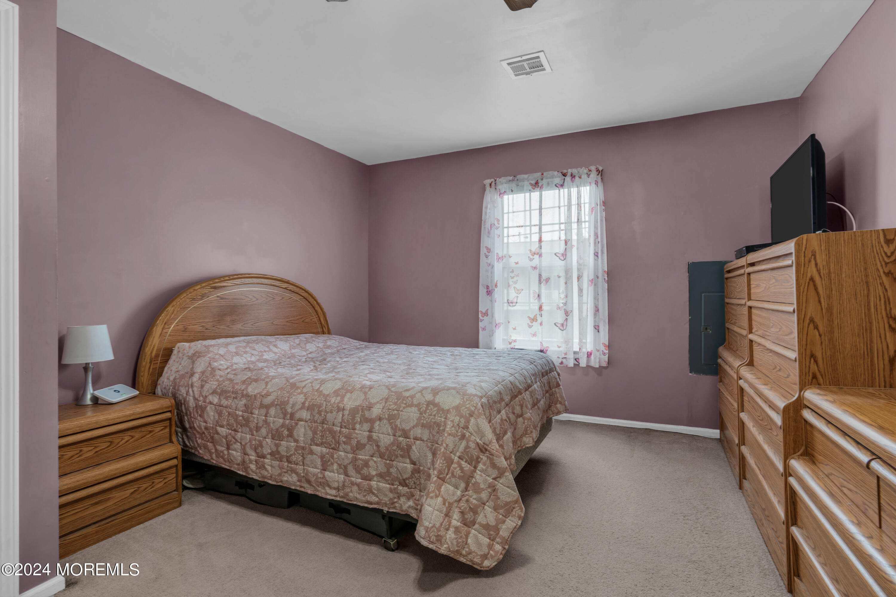 415 Union Avenue Union Beach, NJ 07735 - Photo 11 of 17 a bedroom with a bed and flat tv screen on the dresser