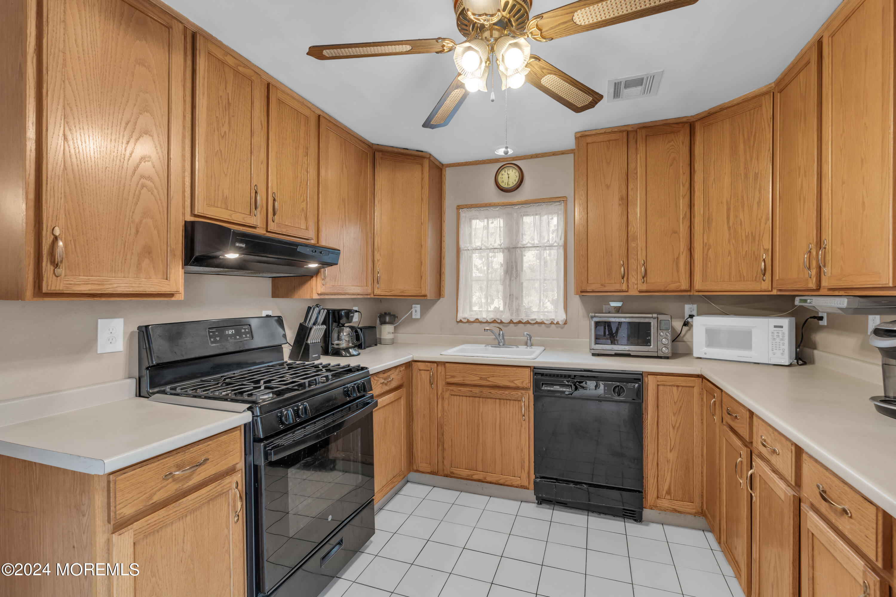 415 Union Avenue Union Beach, NJ 07735 - Photo 6 of 17 a kitchen with a stove cabinets and a window