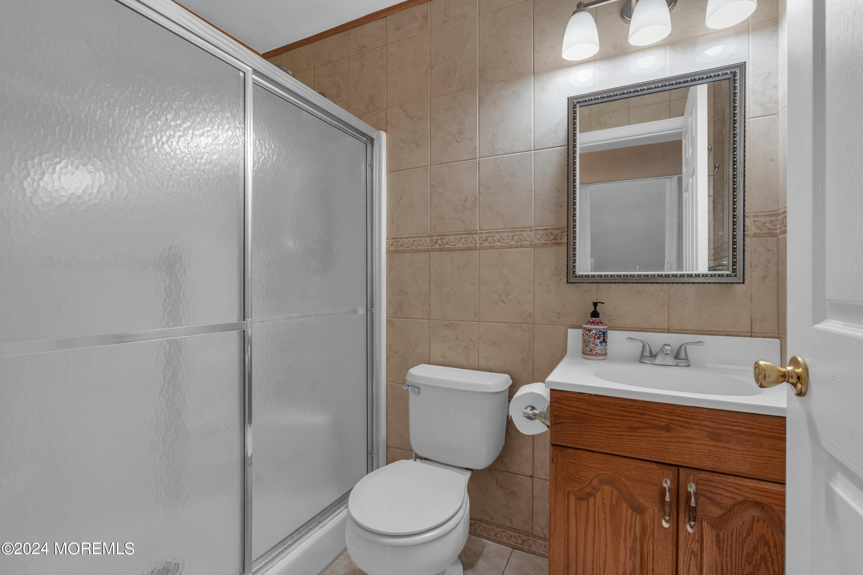 415 Union Avenue Union Beach, NJ 07735 - Photo 8 of 17 a bathroom with a toilet sink vanity and mirror