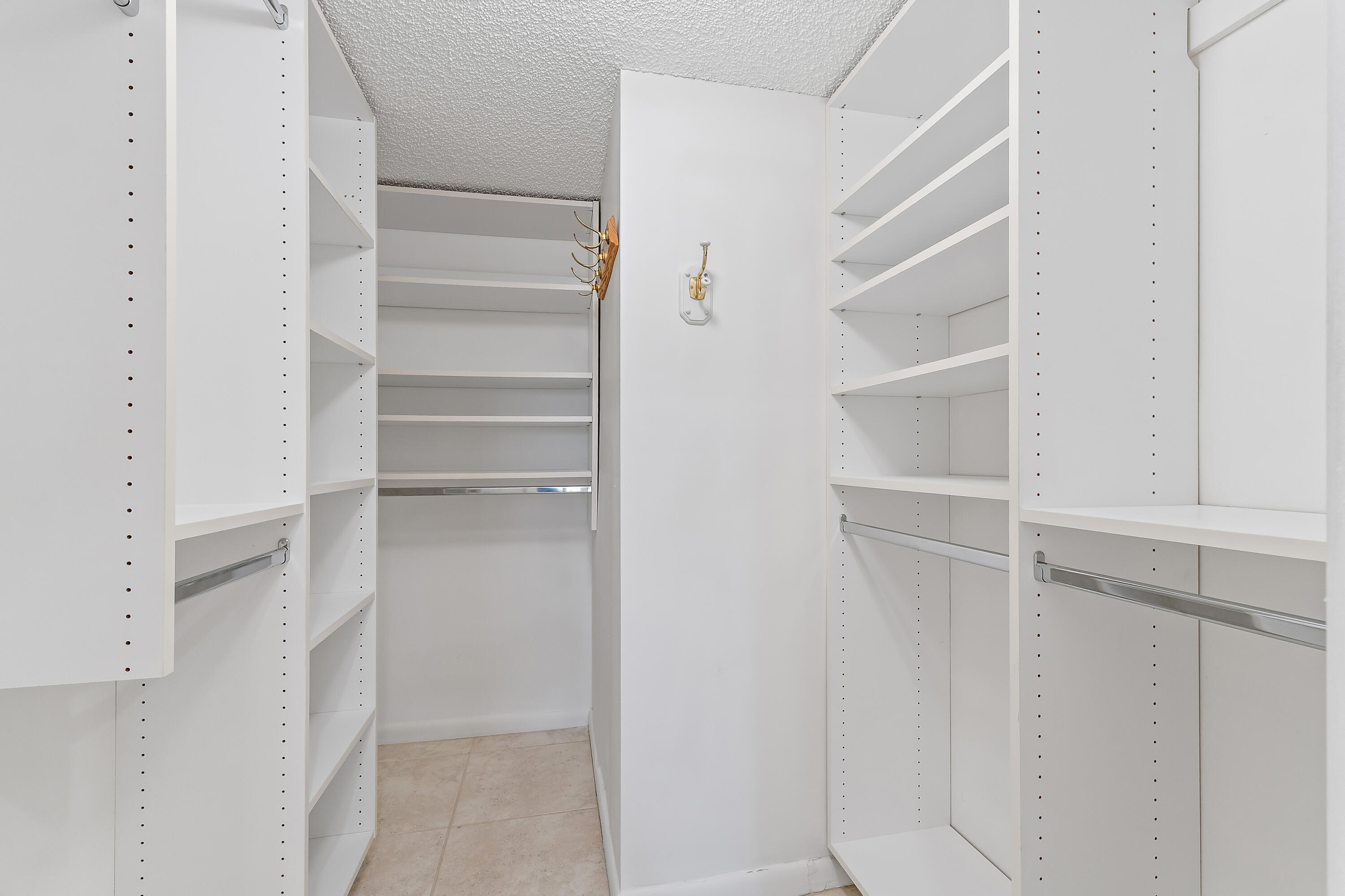 300 Ocean Trail Way, Unit 102 Jupiter, FL 33477 - Photo 17 of 30 a view of walk in closet with empty racks