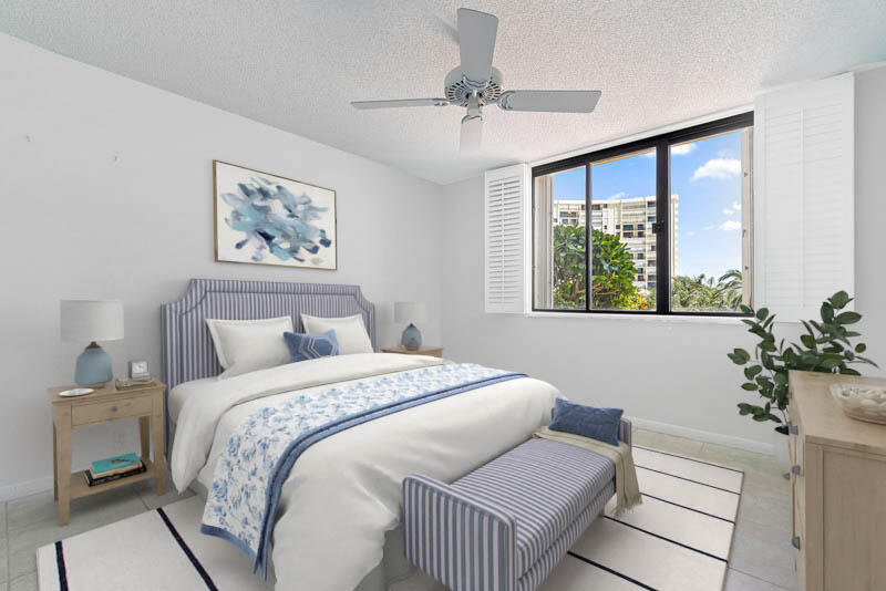 300 Ocean Trail Way, Unit 102 Jupiter, FL 33477 - Photo 19 of 30 a bedroom with a bed and a window