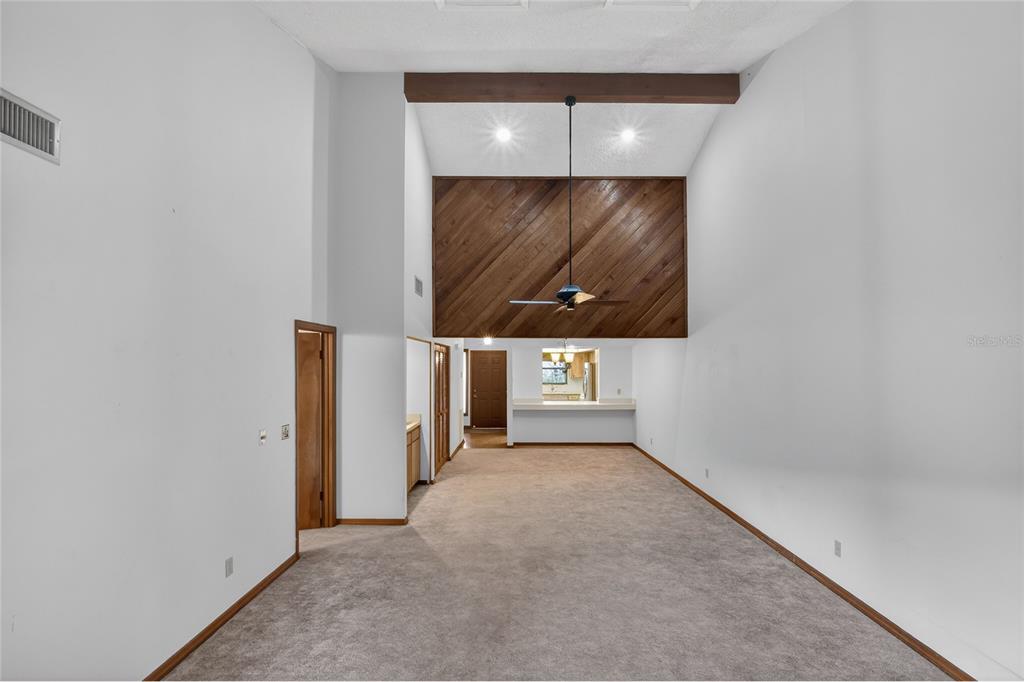 2025 Sylvester Road, Unit E1 Lakeland, FL 33803 - Photo 11 of 37 an empty room with wooden floor and windows