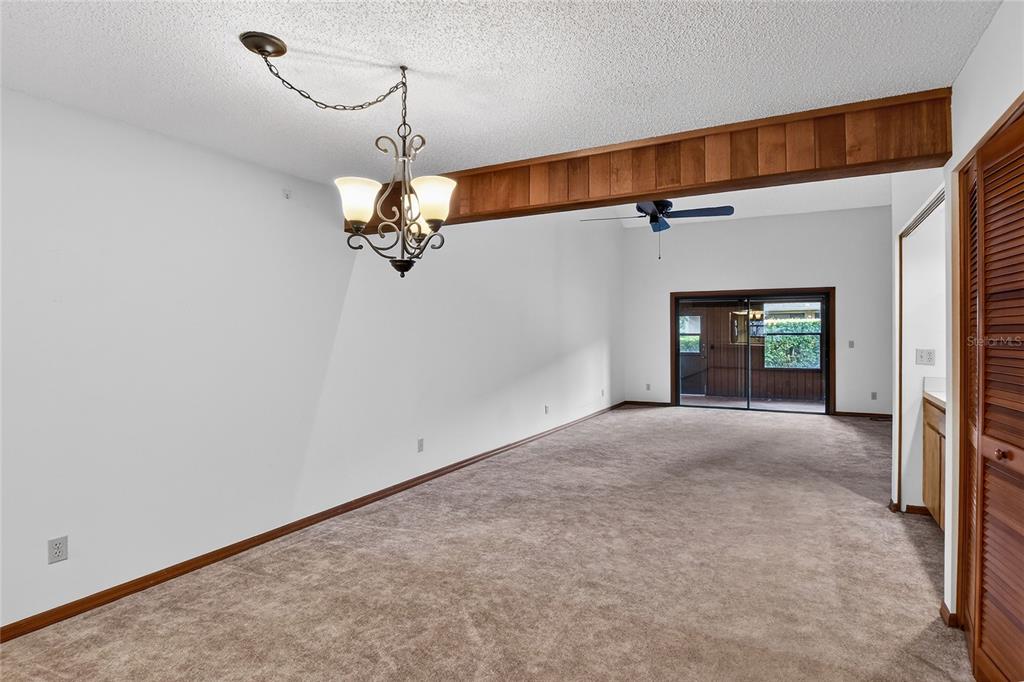 2025 Sylvester Road, Unit E1 Lakeland, FL 33803 - Photo 14 of 37 a view of a room with a hanging light and hardwood floor