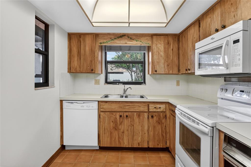 2025 Sylvester Road, Unit E1 Lakeland, FL 33803 - Photo 17 of 37 a kitchen with a sink stove and cabinets
