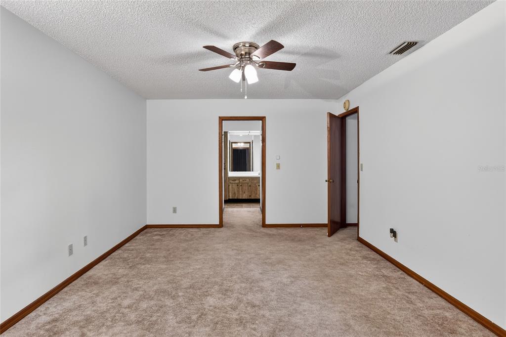 2025 Sylvester Road, Unit E1 Lakeland, FL 33803 - Photo 19 of 37 a view of an empty room with a ceiling fan