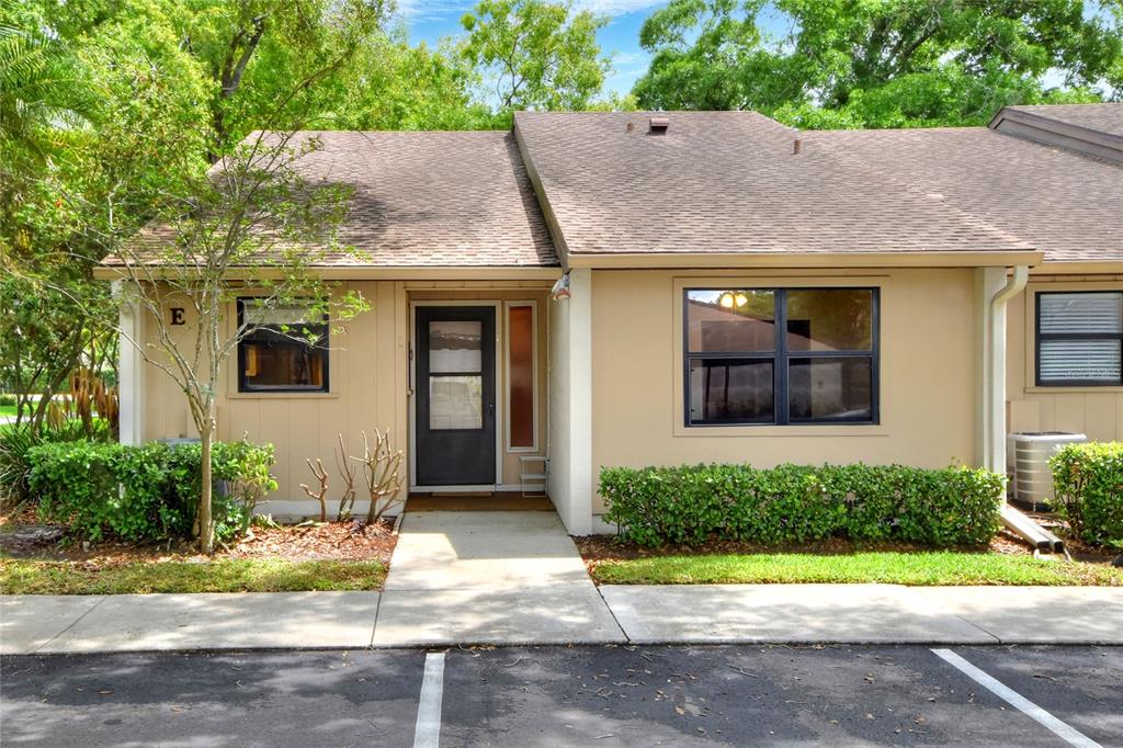 2025 Sylvester Road, Unit E1 Lakeland, FL 33803 - Photo 2 of 37 a view of a house with a yard