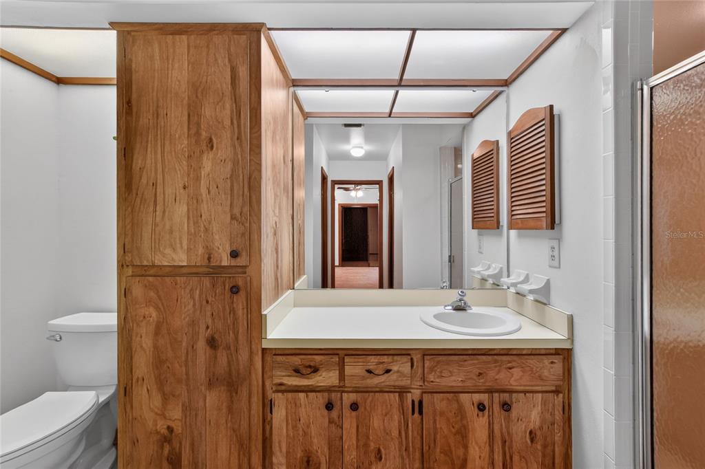 2025 Sylvester Road, Unit E1 Lakeland, FL 33803 - Photo 22 of 37 a bathroom with a sink a toilet and shower