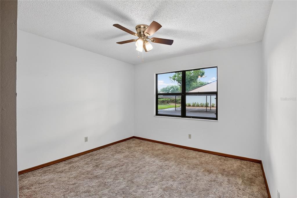 2025 Sylvester Road, Unit E1 Lakeland, FL 33803 - Photo 25 of 37 an empty room with windows and fan