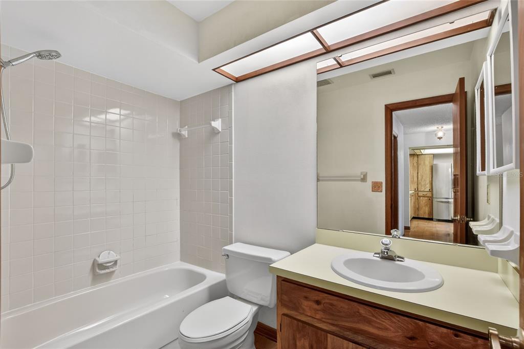 2025 Sylvester Road, Unit E1 Lakeland, FL 33803 - Photo 27 of 37 a bathroom with a sink toilet and shower