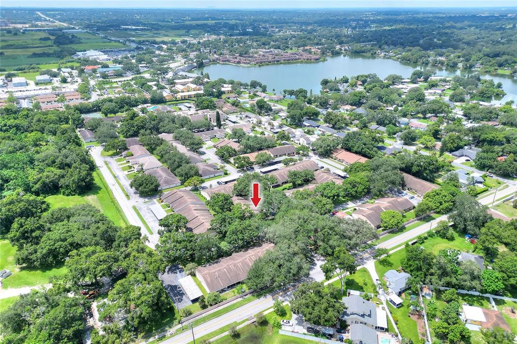 2025 Sylvester Road, Unit E1 Lakeland, FL 33803 - Photo 36 of 37 an aerial view of residential houses with outdoor space and trees